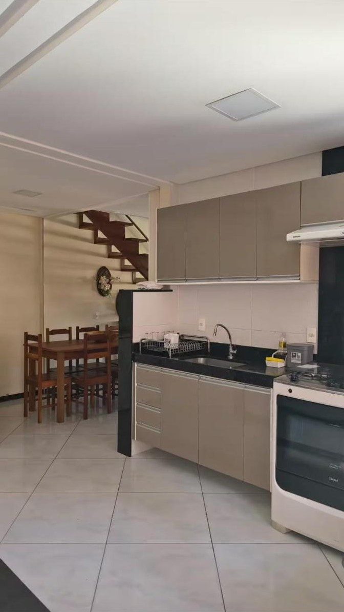 Cozinha com armários, fogão e bancada